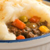 Closeup of Quick and Easy Stove-top Shepherd's Pie in a blue and white bowl