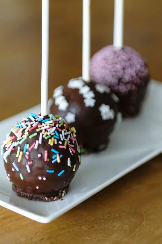 Easy Chocolate Balls or Cake Pops with sprinkles on a white plate