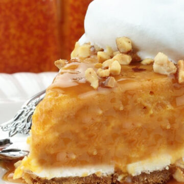 Closeup of Two-Layer Pumpkin Cheesecake on a white plate.