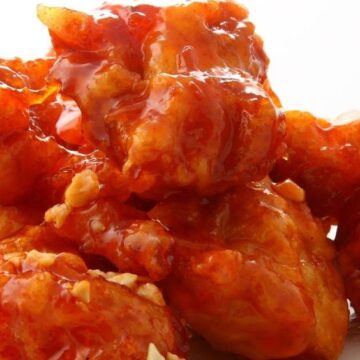 Closeup of Chinese Chicken with Sweet and Sour Sauce with a white background.
