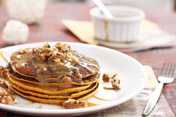 Copycat Harvest Grain Nut IHOP Pancakes on a white plate with a fork beside it.