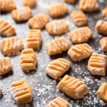 Raw sweet potato gnocchi on a baking sheet.