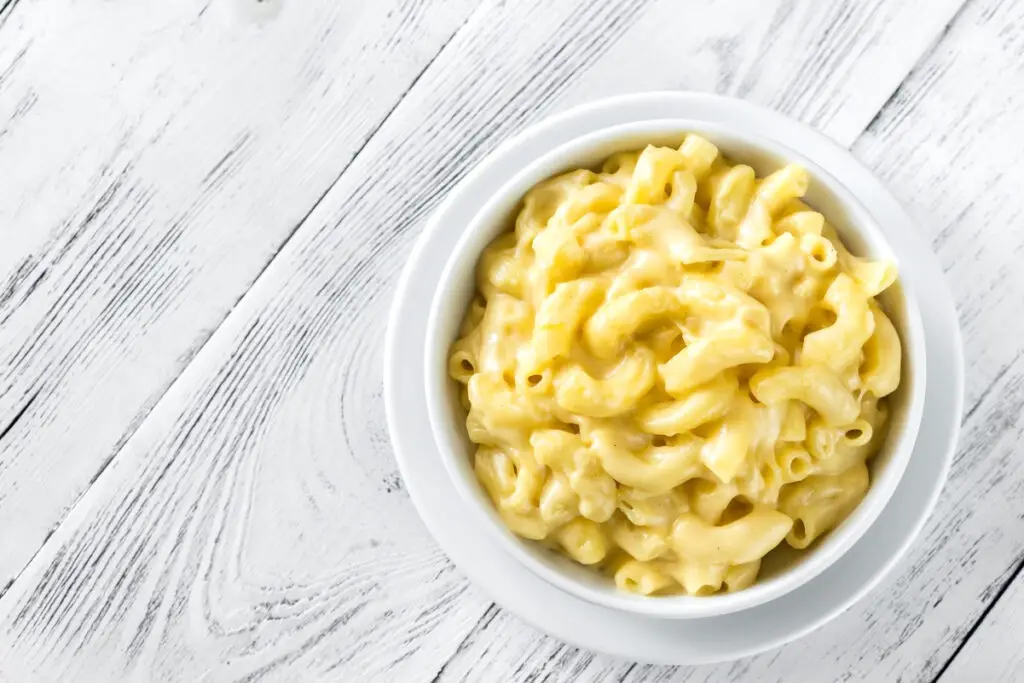 Stove-Top Macaroni and Cheese in a white bowl on a wood background