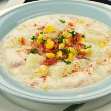 Potato Soup with Ham and Cheddar in a light blue bowl.