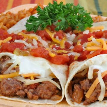 Closeup of Beef and Bean Burritos on a tan plate.