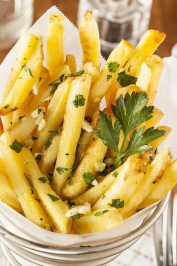 Baked garlic fries in a paper container.
