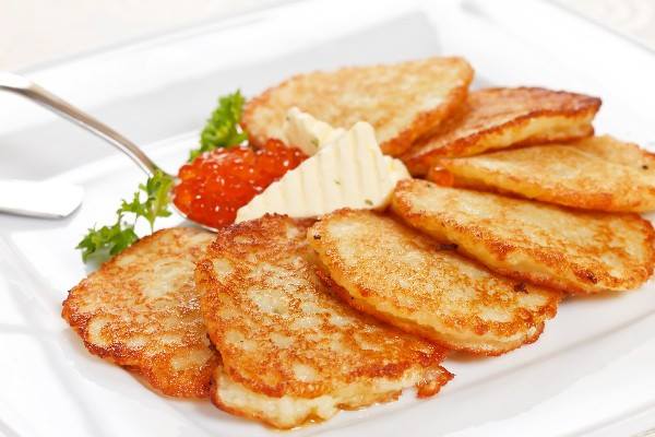 Mashed Potato Pancakes fanned out on a white plate.