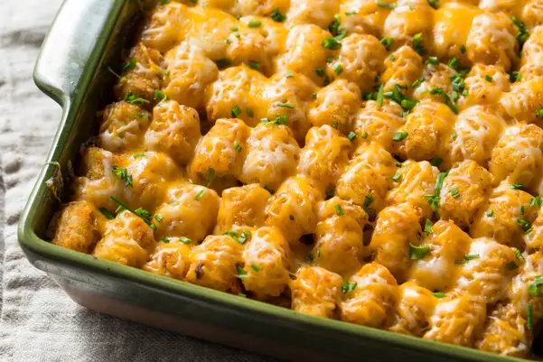 Ground Beef and Tater Tot Casserole in a green casserole dish