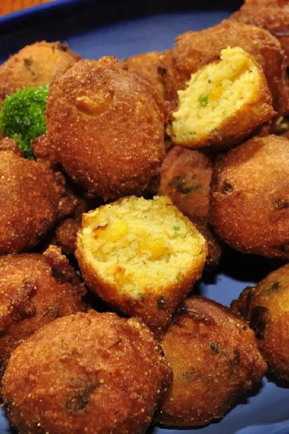 Closeup of Spicy Jalapeno Hush Puppies on a blue surface.
