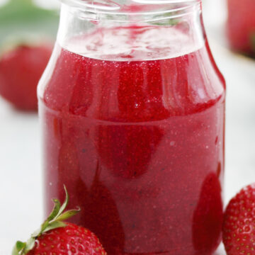 Easy Homemade Strawberry Sauce in a clear glass jar.