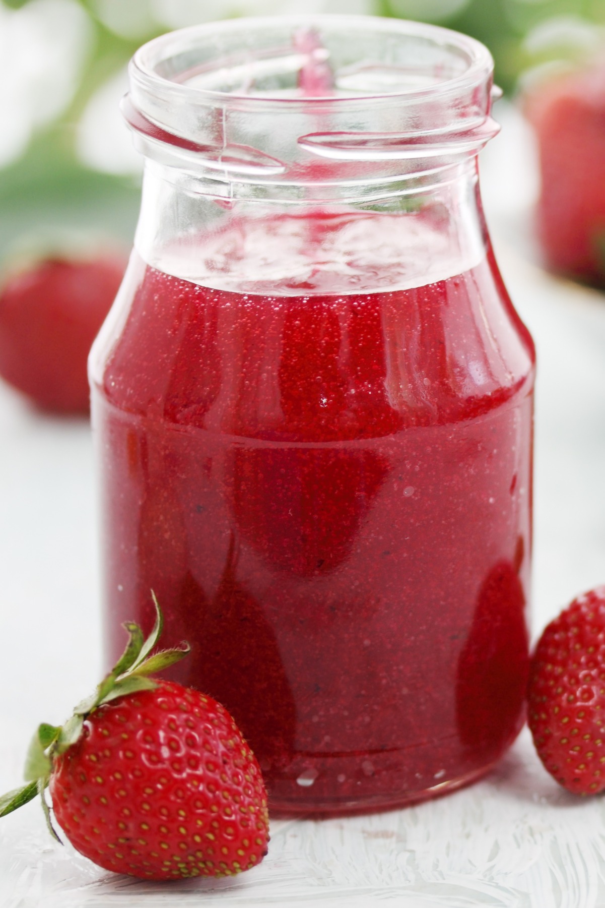 Easy Homemade Strawberry Sauce in a clear glass jar.