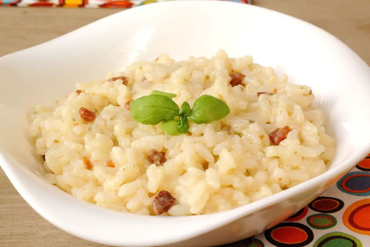 Closeup of Bacon and Parmesan Risotto in a square white bowl.