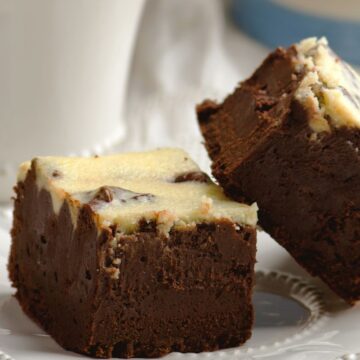 Closeup of 2 Luxurious Bailey's Irish Cream Infused Brownies on a white plate.