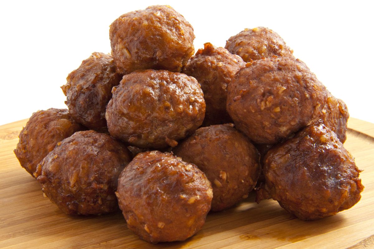 A pile of Irresistible Baked Meatballs on a cutting board.