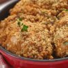 Closeup of Deliciously Easy Parmesan Ranch Chicken Thighs in a red dish.