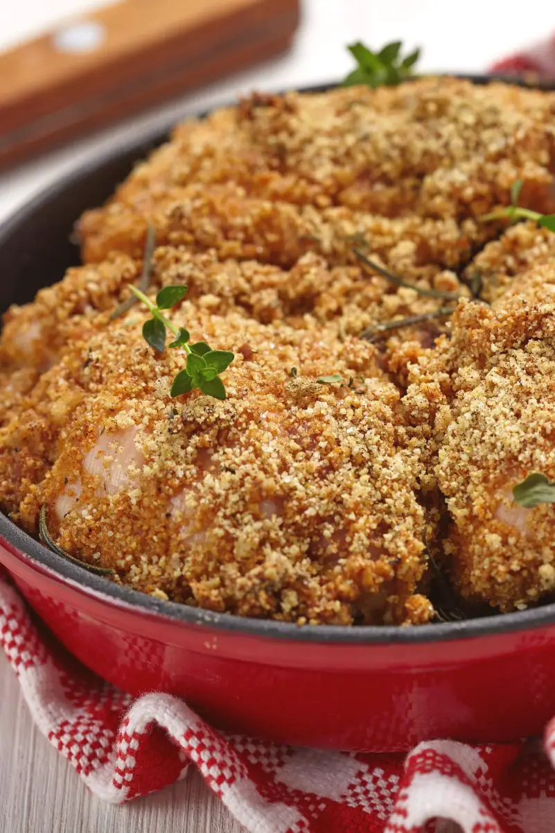 Closeup of Deliciously Easy Parmesan Ranch Chicken Thighs in a red dish.