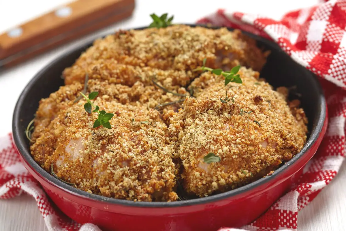 Deliciously Easy Parmesan Ranch Chicken Thighs in a red pan.