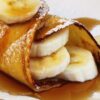Closeup of Delectable Banana Stuffed Crepes on a white plate.