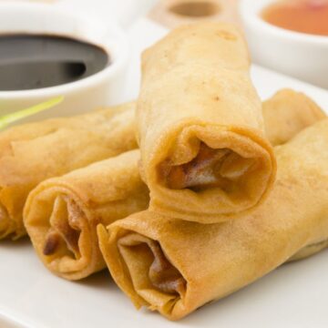 Closeup of Homemade Beef Egg Rolls on a white plate.