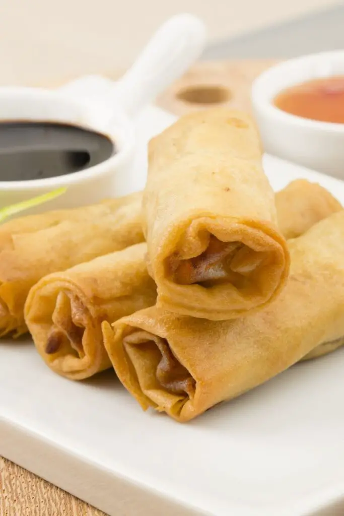 Closeup of Homemade Beef Egg Rolls on a white plate.