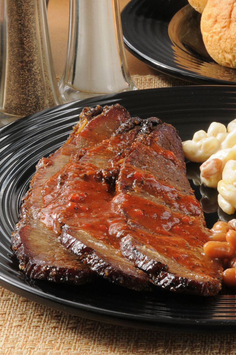 Closeup of Finger-Lickin' Slow Cooker BBQ Beef Brisket on a black plate.