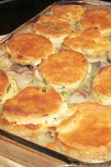 Chicken Stew with Biscuits (The Ultimate Comfort Food) in a clear glass baking dish.