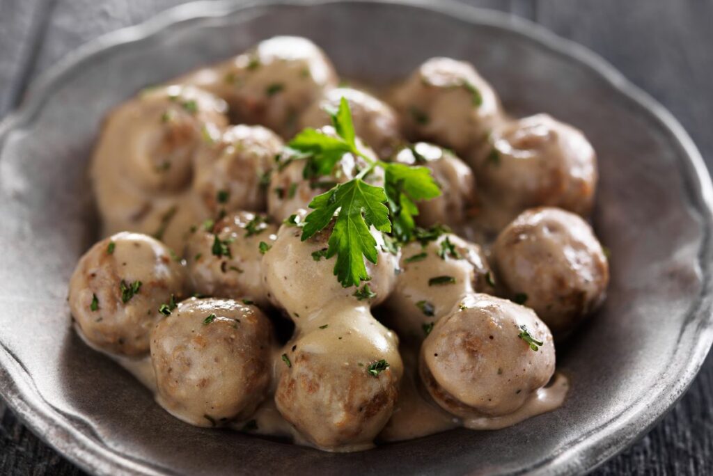 Copycat Ikea Meatballs in a dark brown bowl.