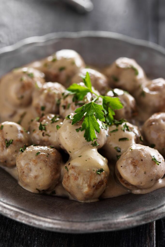 Copycat Ikea Meatballs in a dark brown bowl.