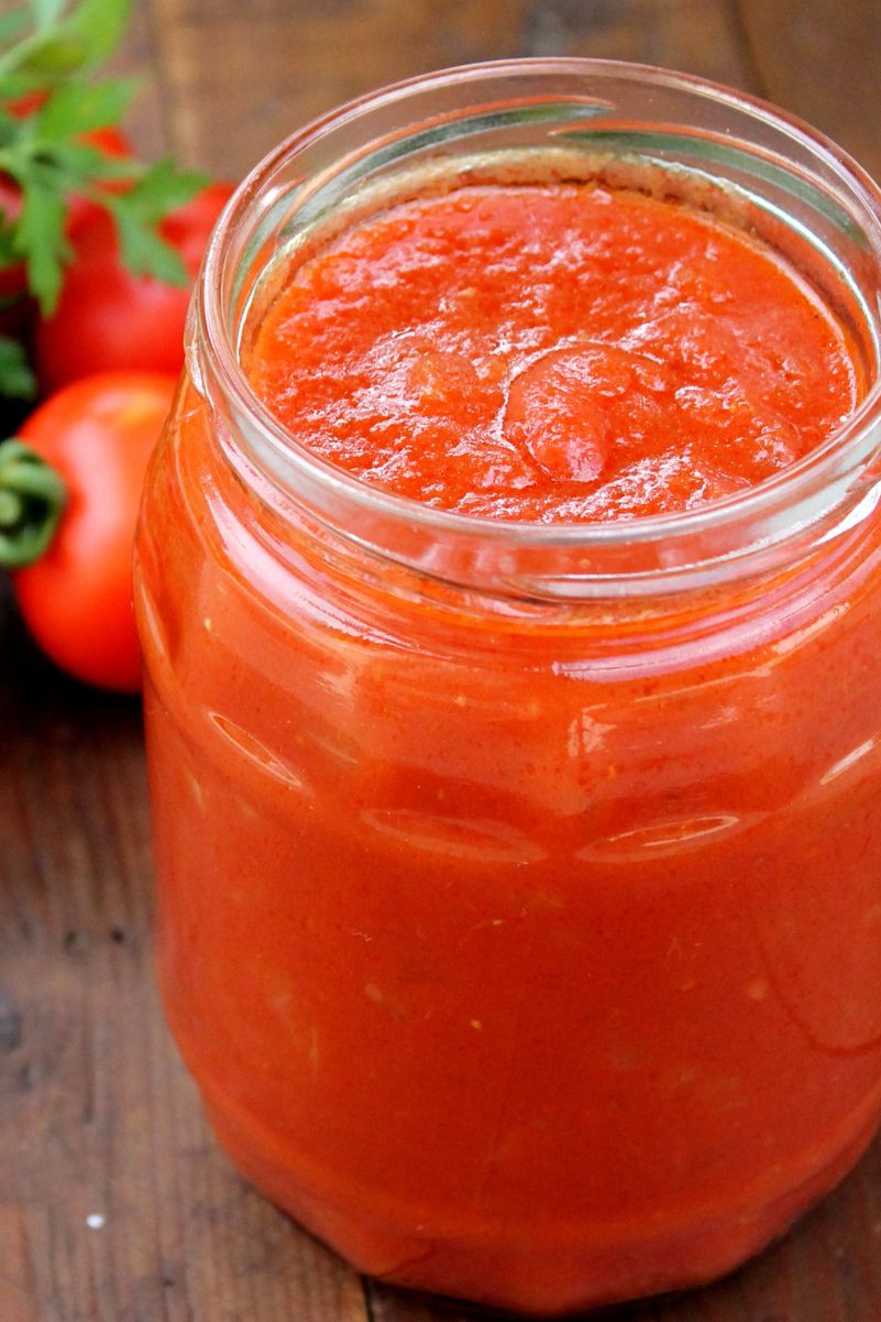 Closeup of Homemade Copycat Pizza Sauce (Pizza Hut) in a clear glass jar. 