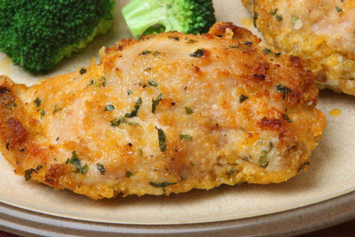 Baked Garlic Cheddar Chicken on a white plate with broccoli.