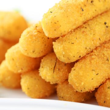 Closeup of a Easy Fried Mozzarella Cheese Sticks stacked in a pyramid.