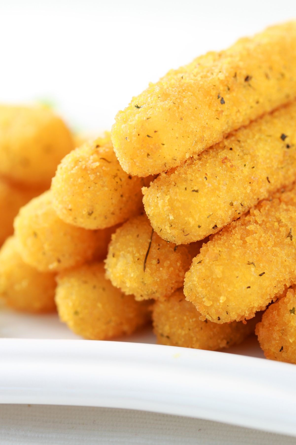 Closeup of a Easy Fried Mozzarella Cheese Sticks stacked in a pyramid.