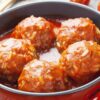 Closeup of Easy Porcupine Meatballs in a red pan.