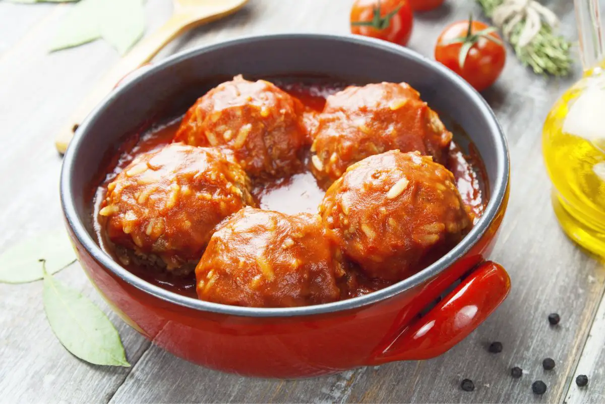 5 Easy Porcupine Meatballs in a red pan.