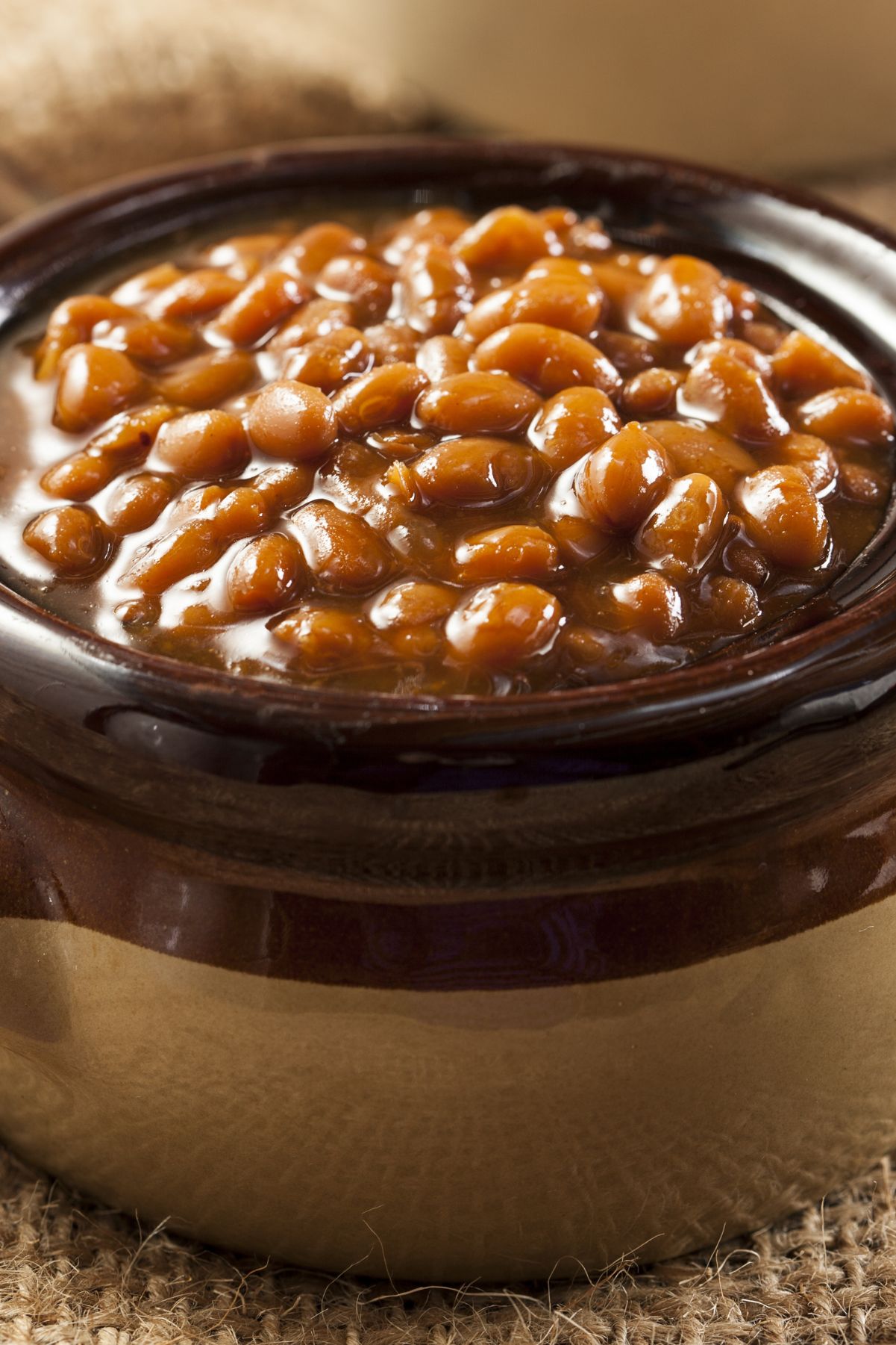 Closeup of Homemade Boston Baked Beans in a brown crock.