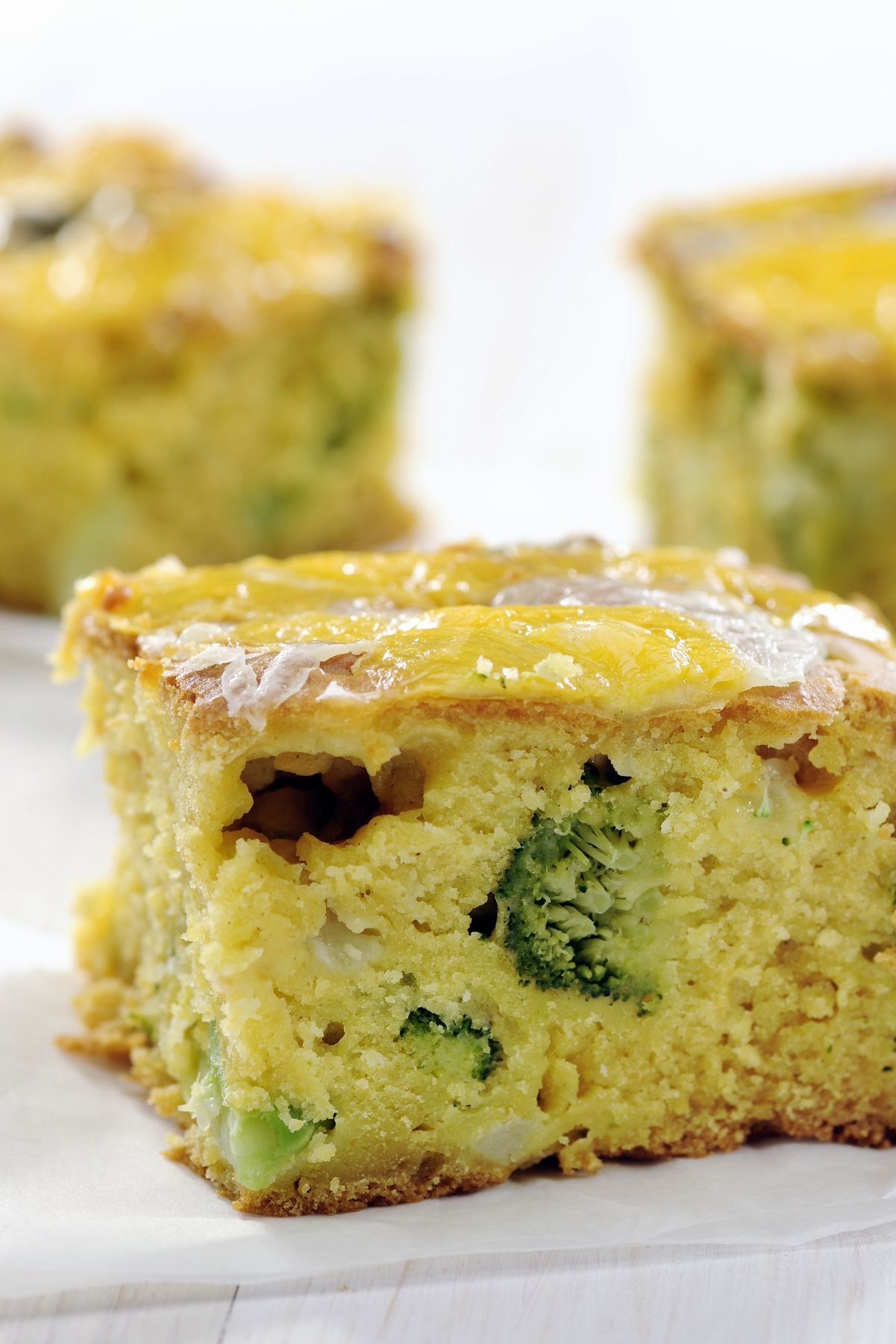 Closeup of Simple Cheddar and Broccoli Cornbread on a white background.