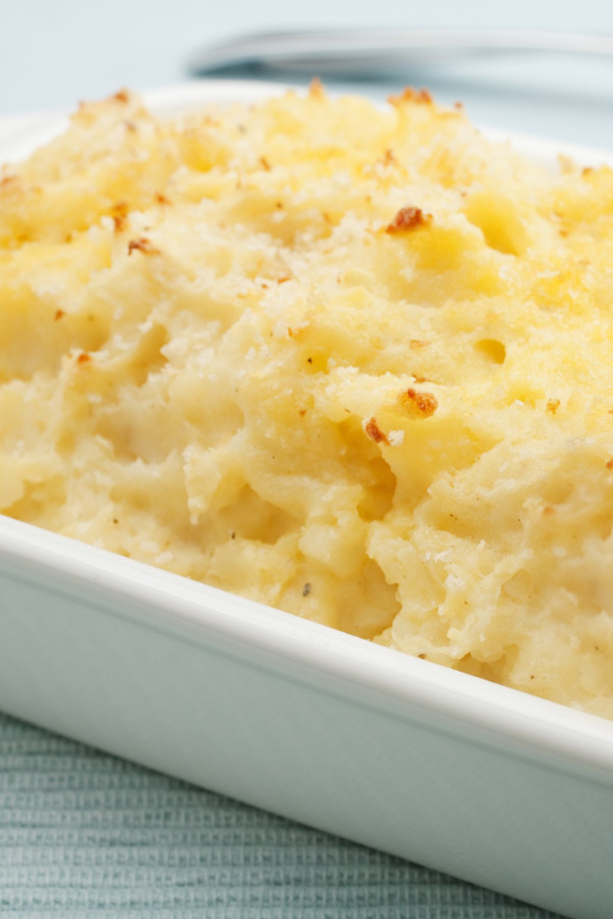 Baked Parmesan Mashed Potatoes in a white baking dish.