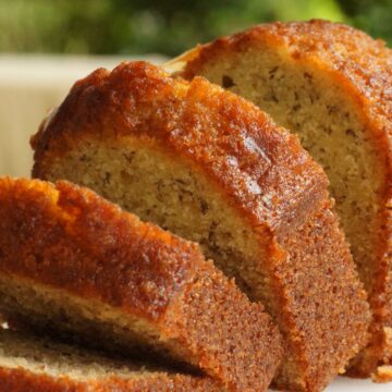 Closeup of sliced Best Banana Bread (Without Nuts) on a white surface.