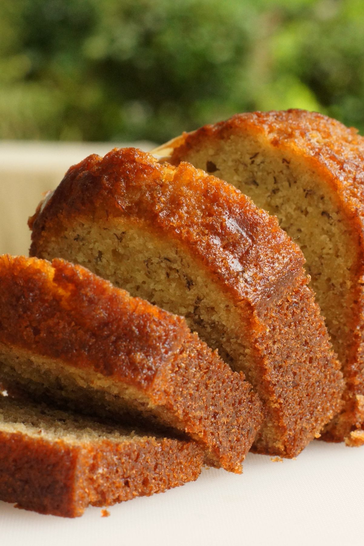 Closeup of sliced Best Banana Bread (Without Nuts) on a white surface.