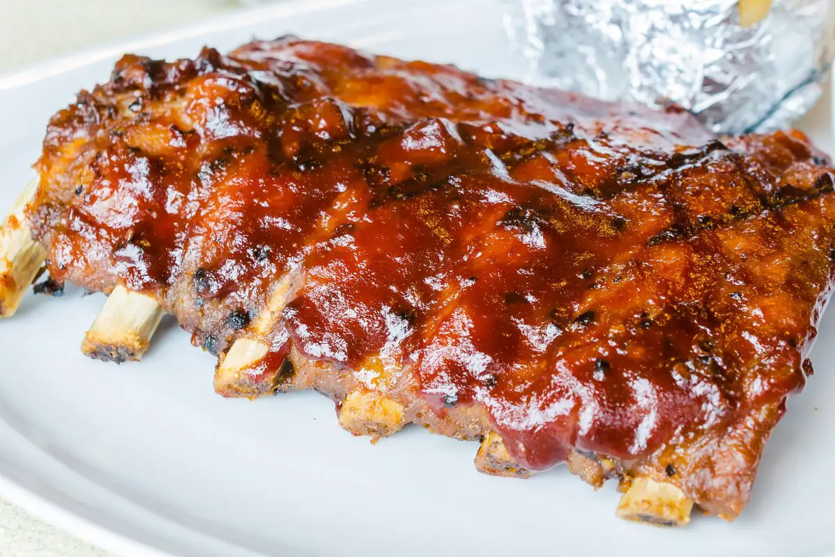 Grilled Whisky Baby Back Ribs on a white plate.