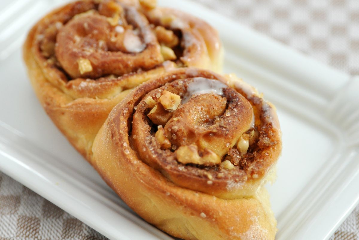 2 Mouthwatering Homemade Cinnamon Buns on a white plate.