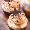 2 Salted Caramel Almond Cupcakes on a dark wooden surface.