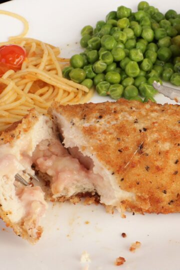 Closeup of Simple Baked Chicken Cordon Bleu on a whtie plate.