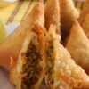 Closeup of Spicy Ground Beef Samosas on a square, white plate.