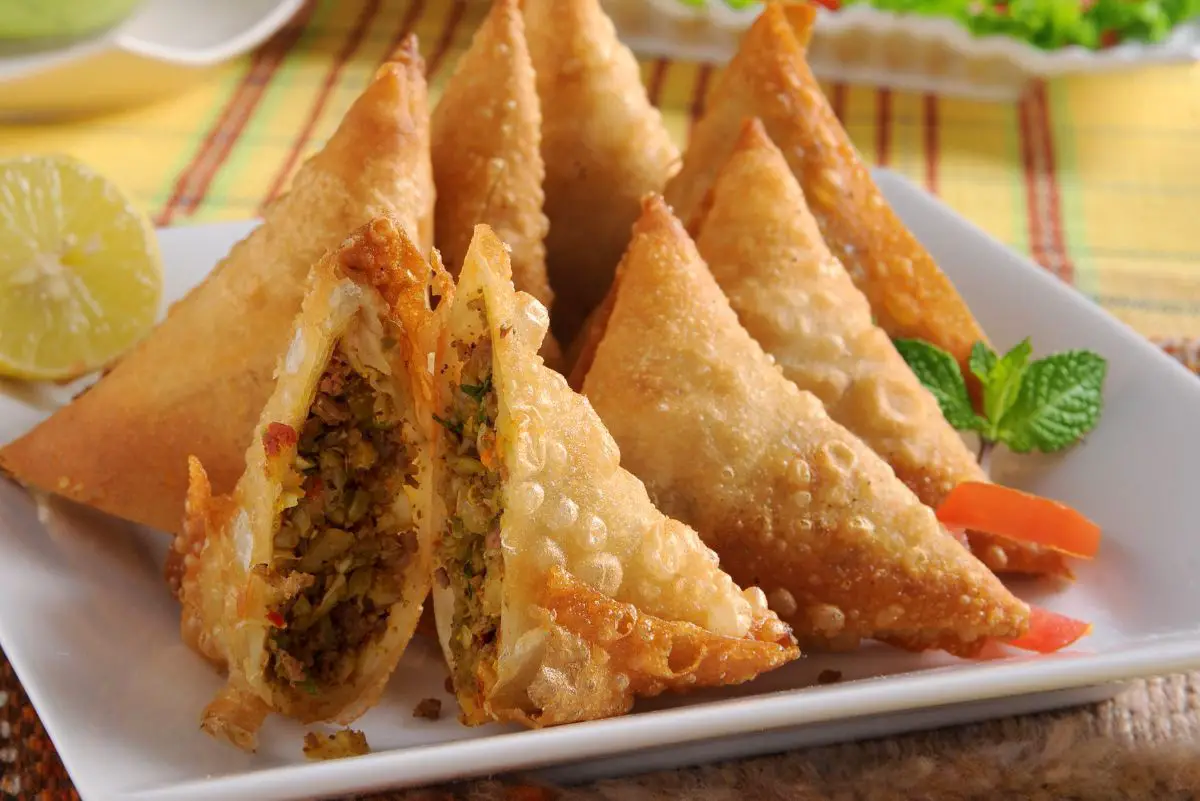 Spicy Ground Beef Samosas on a square, white plate.
