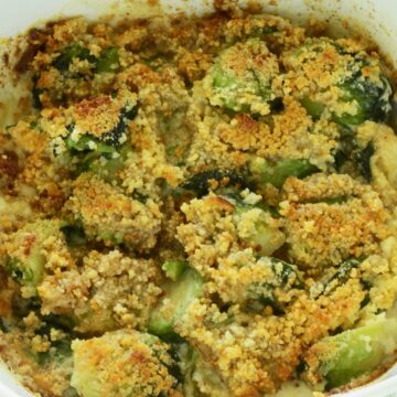 Closeup of Bacon Parmesan Brussels Sprout Gratin in a white casserole dish.