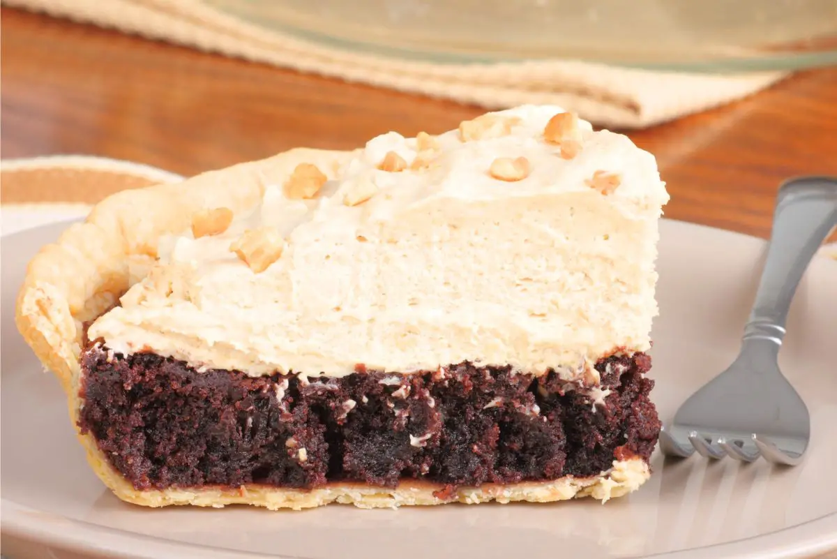 Closeup, side view of a slice of Must Try Peanut Butter Brownie Pie.