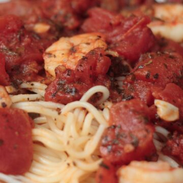 Closeup of Quick and Easy Shrimp and Basil Pasta on a white plate.