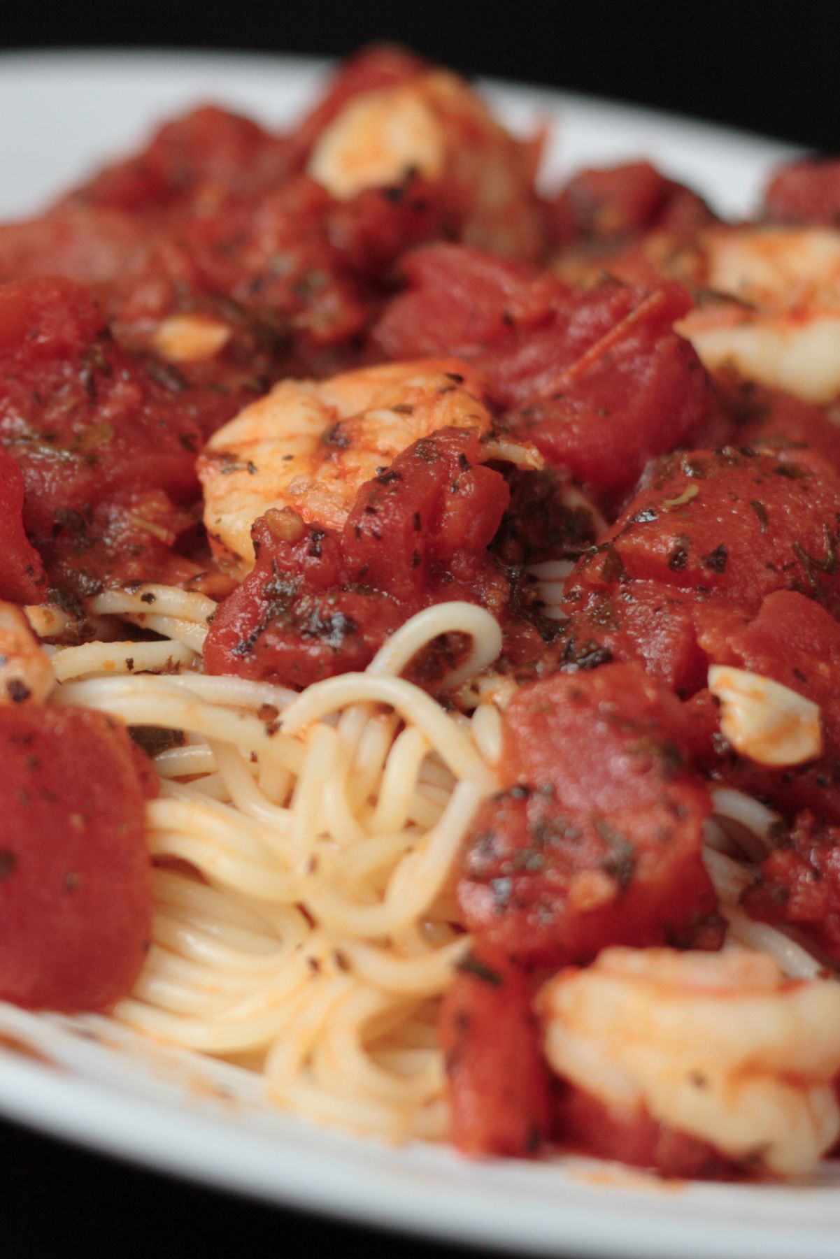 Closeup of Quick and Easy Shrimp and Basil Pasta on a white plate.