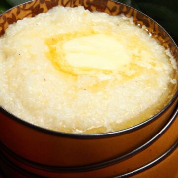 Closeup of Ultimate Southern Cheese Grits in a brown bowl.